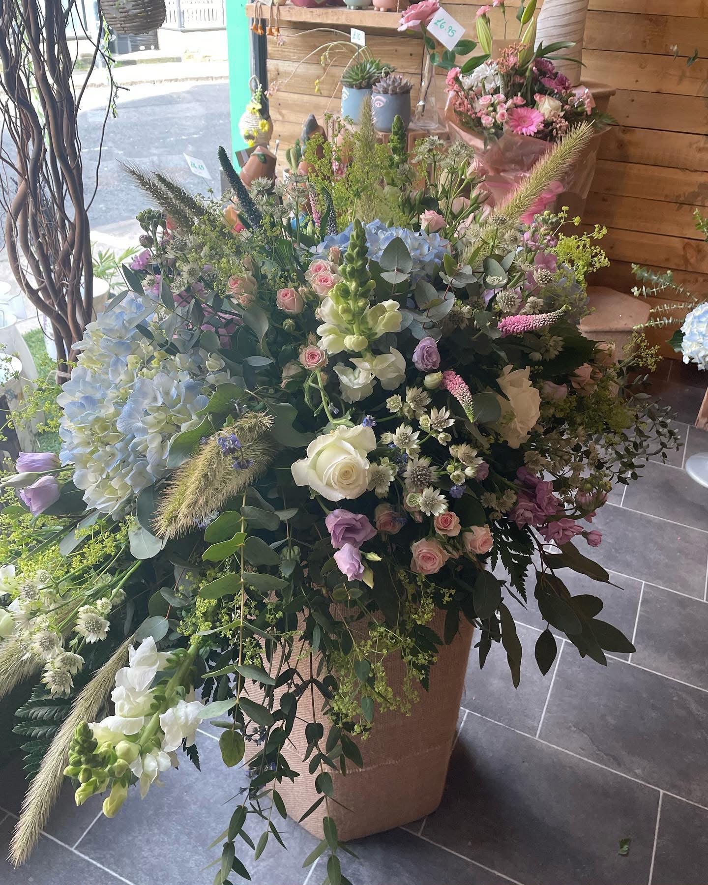 A soft blue, cream and pink floral arrangement