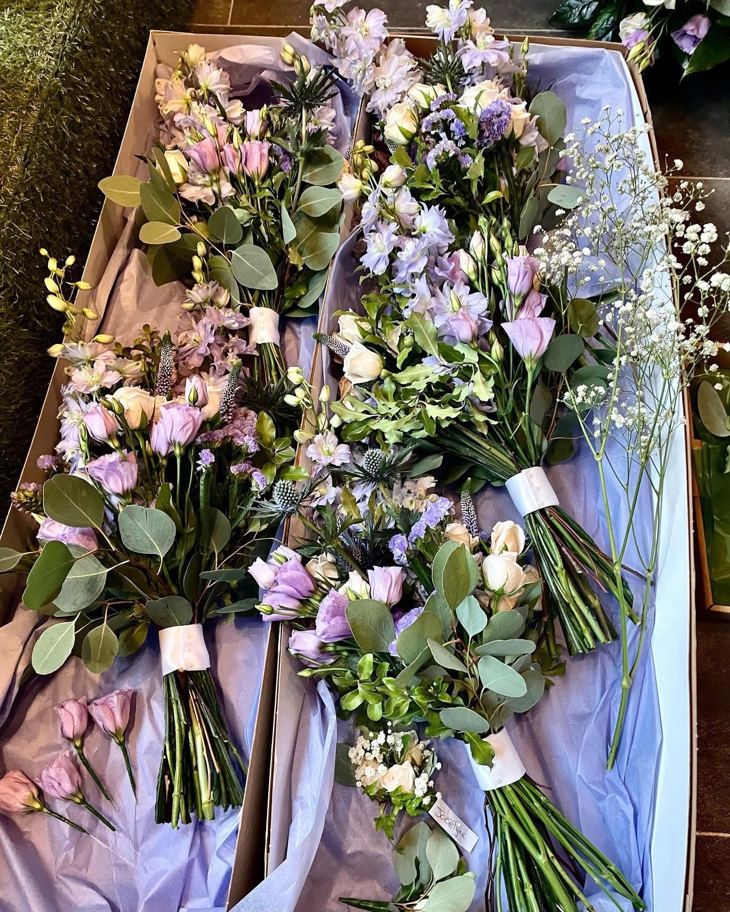 Pastel bridal bouquets with eucalyptus and ribbon